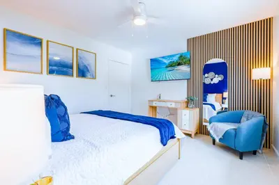 a bedroom with a bed and a blue chair at Marina | Top Location | 8PPL | Parking | Laundry in Miami