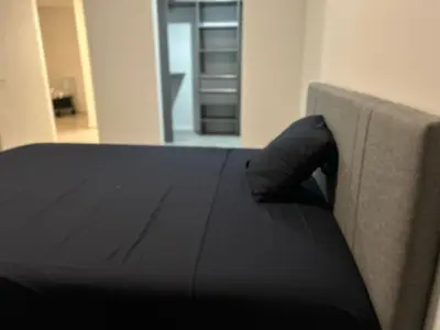 a bed with a black blanket on top of it at Downtown Miami Luxury Condo apartment in Miami