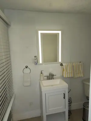 a white bathroom with a sink and a mirror at 1161 Efficency Miami-Lakes in Tamiami