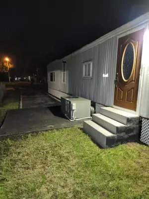a house with a door and stairs next to a yard at 1161 Efficency Miami-Lakes in Tamiami
