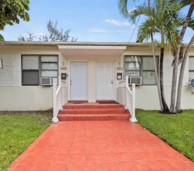 a house with a red brick walkway in front at Stay in Brickell near Kaseya Center & South Beach in Miami