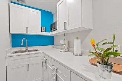 a kitchen with white cabinets and a sink at Charming Hideaway Near Beach, Nightlife & Shops in Fort Lauderdale