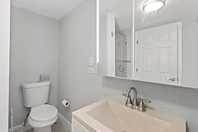 a white bathroom with a toilet and a sink at Charming Hideaway Near Beach, Nightlife & Shops in Fort Lauderdale