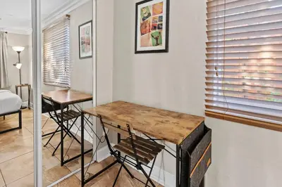 a small room with a table and a bed at Prime Location – Walkable to Wilton Drive in Fort Lauderdale