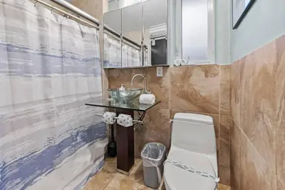 a bathroom with a sink and a toilet at Prime Location – Walkable to Wilton Drive in Fort Lauderdale