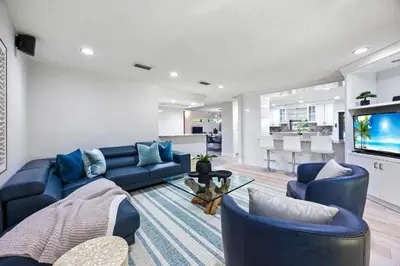 a living room with blue couches and a tv at Cherry RoyaleGrand Villa in Davie