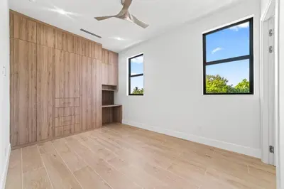 an empty living room with white walls and a window at Jungle Serene Lux Home with Pool Sauna Ice Bath in Fort Lauderdale