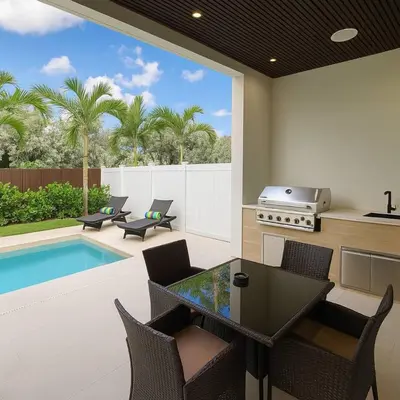 a patio with a table and chairs and a pool at Jungle Serene Lux Home with Pool Sauna Ice Bath in Fort Lauderdale