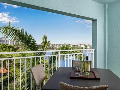a table and chairs on a balcony with a view at Marriott's Villas at Doral 2BR Apartment with Resort Access in Miami