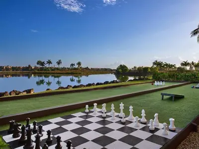 a chess board on a lawn next to a lake at Marriott's Villas at Doral 2BR Apartment with Resort Access in Miami