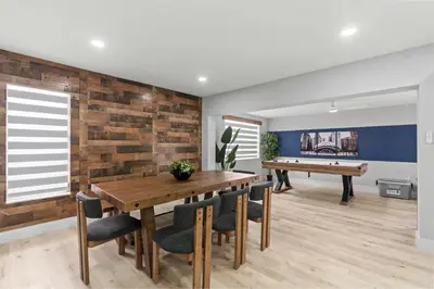 a dining room with a wooden table and a ping pong table at Chicago Vibe Heated Pool 5BR 2BTH in Miami