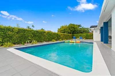 a swimming pool in the backyard of a house at Chicago Vibe Heated Pool 5BR 2BTH in Miami