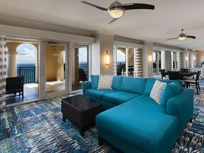a living room with a blue couch and a table at Marriott's BeachPlace Towers Studio Apartment with Resort Access in Fort Lauderdale