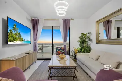 a living room with a couch and a table at Chic 2-Bedroom Downtown Condo with Breathtaking City & Waterfront Views in Miami