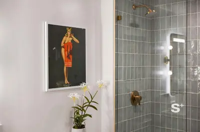 a bathroom with a painting of a woman in a red dress at Chic 2-Bedroom Downtown Condo with Breathtaking City & Waterfront Views in Miami