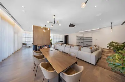 a living room with a couch and a table and chairs at Chic 2-Bedroom Downtown Condo with Breathtaking City & Waterfront Views in Miami