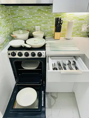 a kitchen with a stove with plates on it at Beautiful Studio w Amazing View of Miami Skyline in Miami Beach
