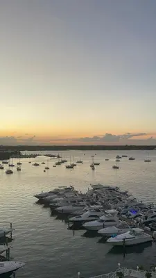 a group of boats in the water at sunset at Beautiful Studio w Amazing View of Miami Skyline in Miami Beach