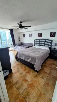 a bedroom with two beds and a ceiling fan at 36th Floor Brickell Suite with City Skyline and Bay Views in Miami