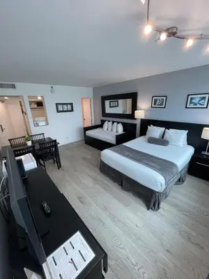 a hotel room with a bed and a couch and a table at Shine Suites Studio 8 in Miami Beach