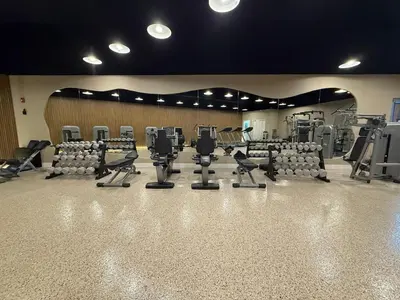 a gym with rows of chairs and treadmills at Shine Suites Studio 8 in Miami Beach