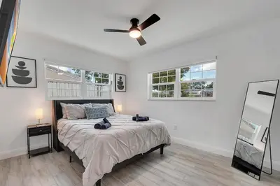 a bedroom with a bed with a ceiling fan at Hope Casa Heated Pool and BBQ 4bedrooms 2baths by HostyMosty in Hollywood