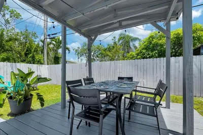 a patio with a table and chairs on a deck at Hope Casa Heated Pool and BBQ 4bedrooms 2baths by HostyMosty in Hollywood
