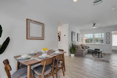 a dining room and living room with a table and chairs at Hope Casa Heated Pool and BBQ 4bedrooms 2baths by HostyMosty in Hollywood