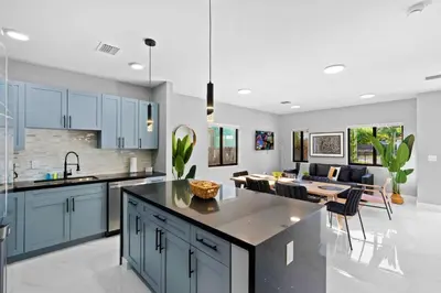 a kitchen with blue cabinets and a dining room at Family-Friendly Apt in Miami - Sleeps 4, Near Everything in Miami