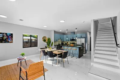 a kitchen and dining room with a table and chairs at Urban Comfort - 20min to Beach & Airport in Miami