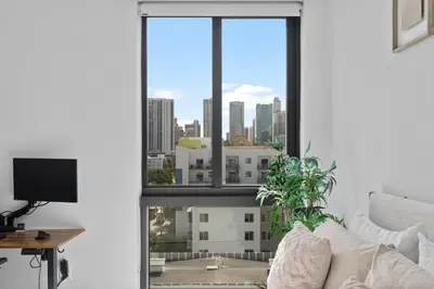 a living room with a window view of a city at Luxury Pent House with Downtown Views in Miami