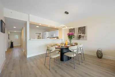 a dining room and kitchen with a table and chairs at Golden Bay 504 in Sunny Isles Beach