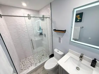 a bathroom with a shower and a toilet and a sink at The LuxeLanding MIA- Swimming pool, Oasis Lounge, Mini Golf, BBQ and Hibachi Grill , and Outdoor Games in Miami