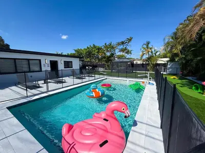 a swimming pool with a pink rubber duck in it at The LuxeLanding MIA- Swimming pool, Oasis Lounge, Mini Golf, BBQ and Hibachi Grill , and Outdoor Games in Miami