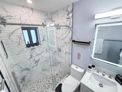 a bathroom with a shower and a toilet and a sink at The LuxeLanding MIA- Swimming pool, Oasis Lounge, Mini Golf, BBQ and Hibachi Grill , and Outdoor Games in Miami