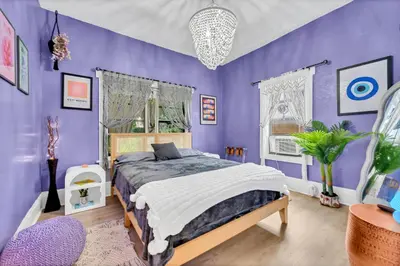 a purple bedroom with a bed and a purple wall at Casa Alaïa West Brickell Sleeps 20 Pool&Spa in Miami