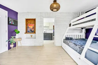 a bedroom with two bunk beds and a kitchen at Casa Alaïa West Brickell Sleeps 20 Pool&Spa in Miami