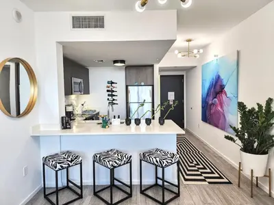 a kitchen with a counter and two stools at Electric Luxury Downtown Bayfront Brickell in Miami