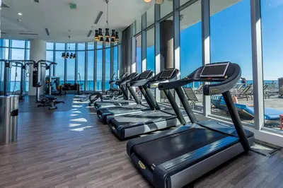 a gym with a row of treadmills at Elegant Beachfront Retreat in Hollywood