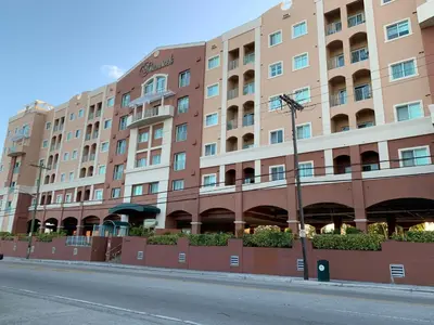 a large apartment building on the side of a street at 202 Private bedroom in Miami - Coral Gables in Miami