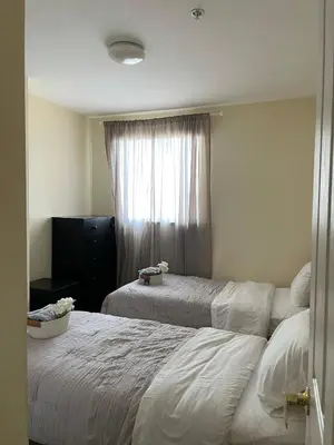 a hotel room with two beds and a window at 202 Private bedroom in Miami - Coral Gables in Miami
