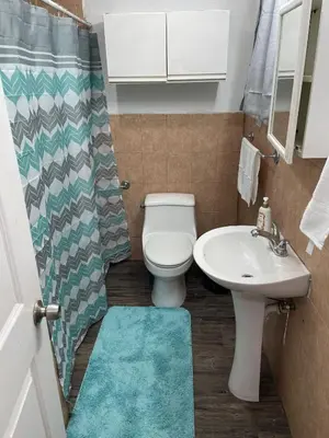 a bathroom with a toilet and a sink at El Rincon De Tati in Miami