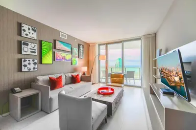 a living room with a couch and a table at Charming Condo for Your Dream Vacation in Hollywood