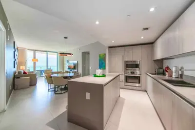 a kitchen and living room with a table and chairs at Charming Condo for Your Dream Vacation in Hollywood