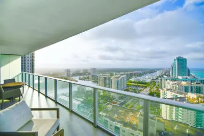 a balcony with a view of a city at Charming Condo for Your Dream Vacation in Hollywood
