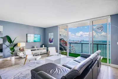 a living room with a couch and a large window at Top Floor Front Facing Penthouse With Breathtaking Views in Miami