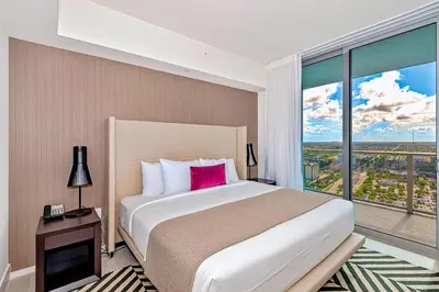 a bedroom with a large bed and a large window at Modern Condo Retreat with Ample Space in Hollywood