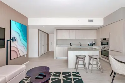 a kitchen and living room with a couch and a table at Modern Condo Retreat with Ample Space in Hollywood