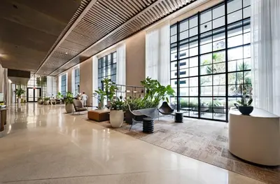 a lobby with potted plants and large windows at Stylish City Condo in the Heart of Downtown Miami in Miami