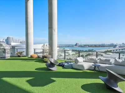 a patio with couches and chairs on top of a building at MVR Stunning Views Superhost Service in Miami